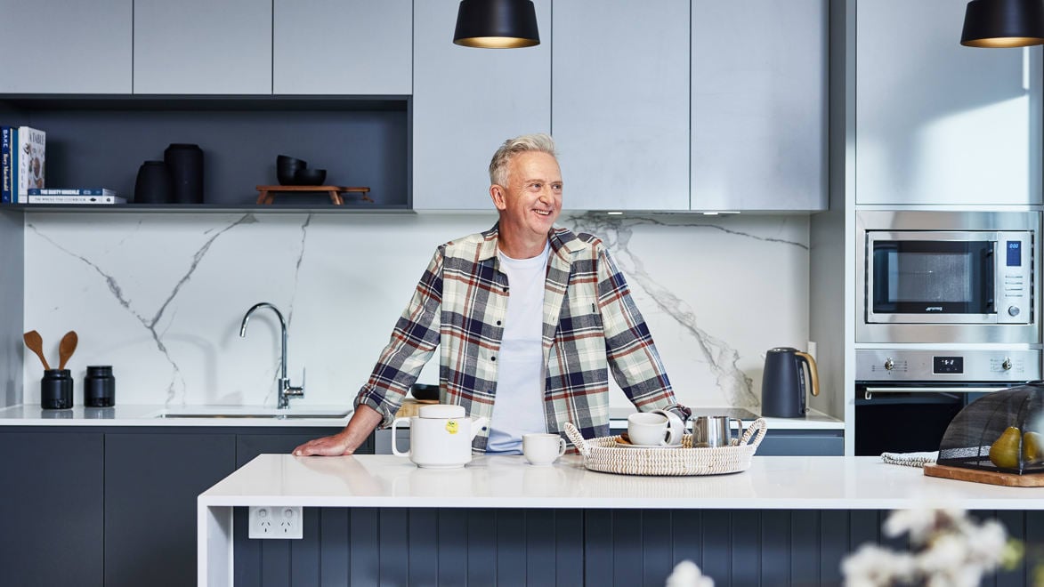 Homeowner making coffee in kitchen of his Stockland Halcyon home