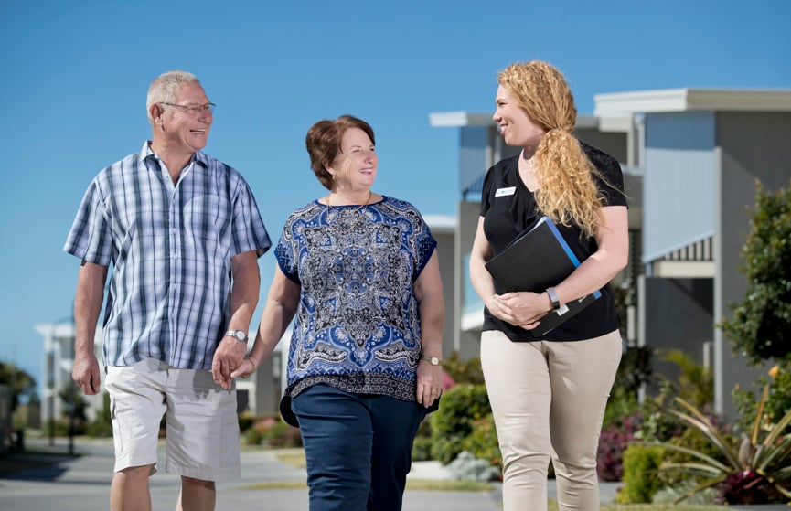 A community manager walks with homeowners in a Stockland Halcyon community