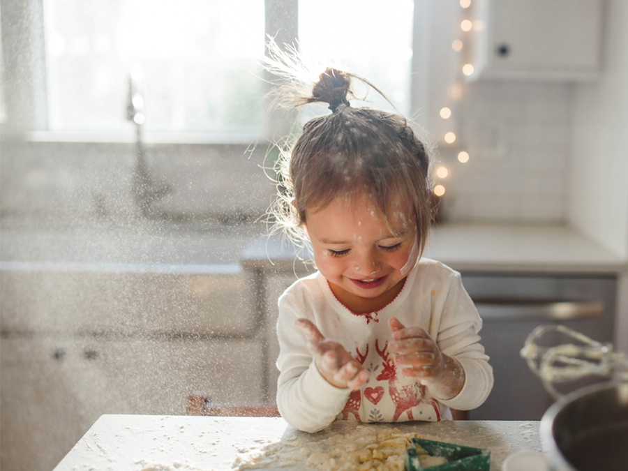 Little girl playing with flour