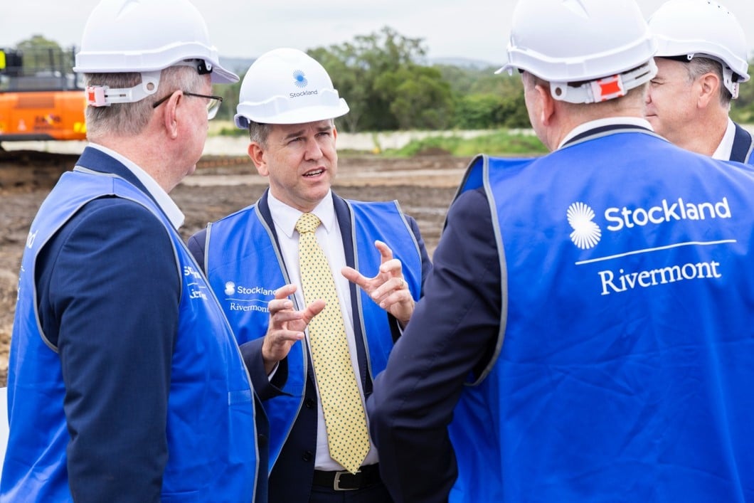 A group of men wearing hard hats and vests.