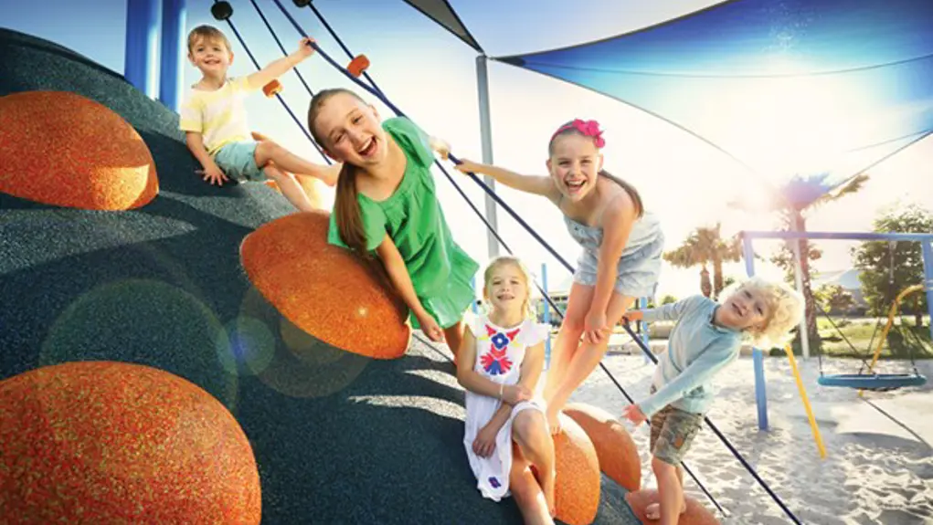 A group of kids playing in a community playground