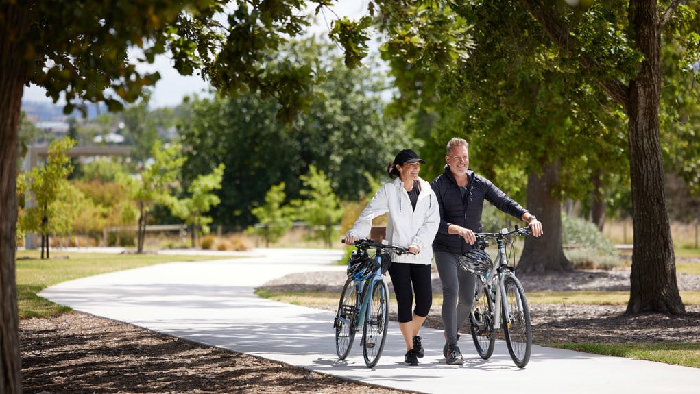 Halcyon Berwick, couple walking with bikes