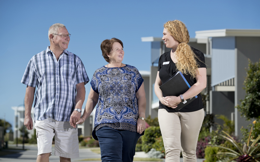 A community manager walks with homeowners in a Stockland Halcyon community
