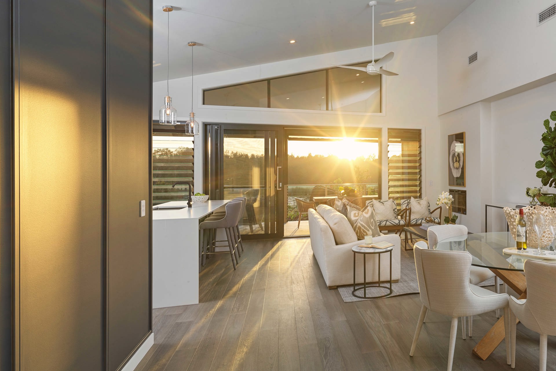 Interior shot of Halcyon Greens fairway home with the sunset peering through the home 