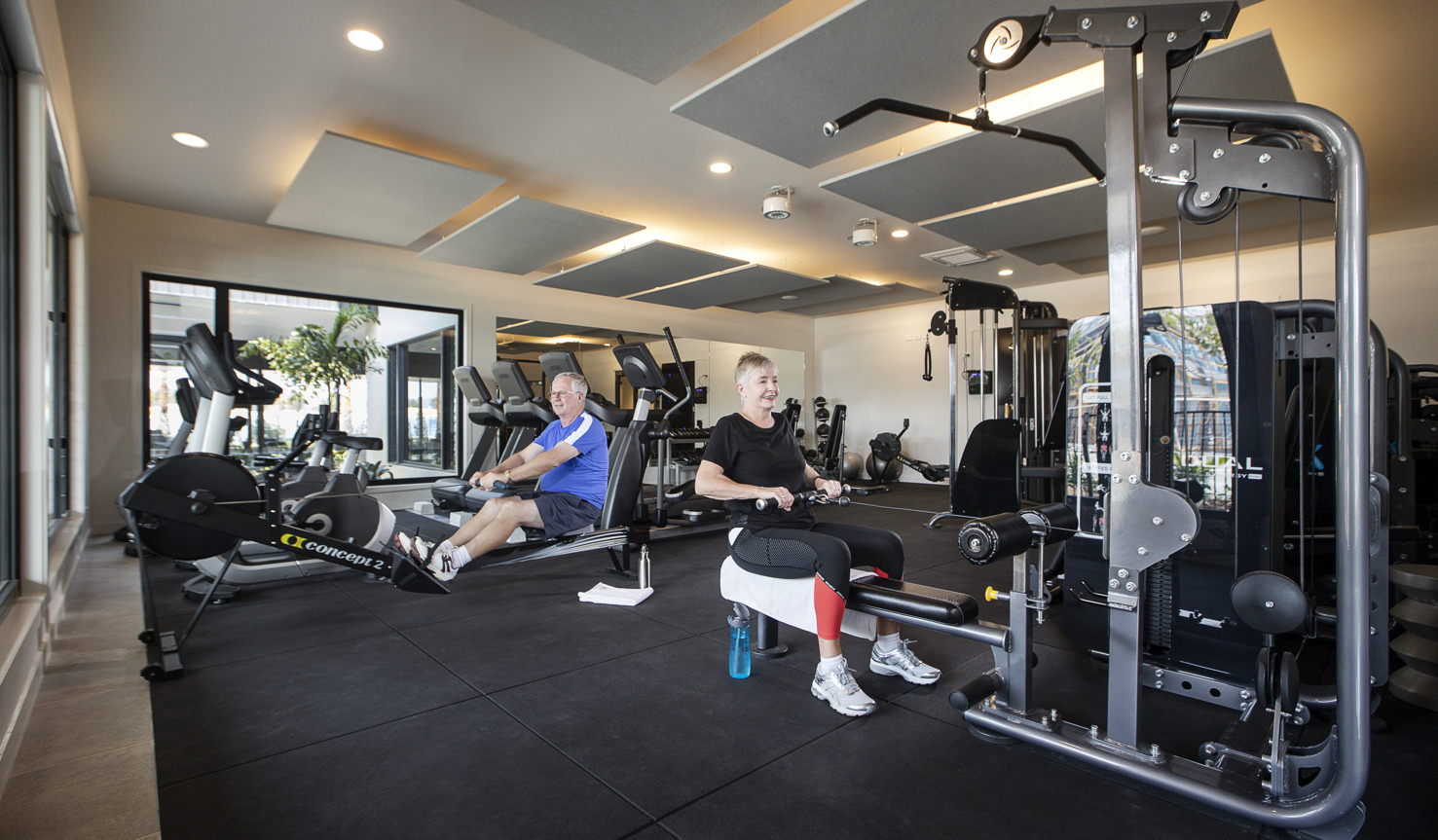 Action shot of Homeowners using exercising machines in the Halcyon Greens gym