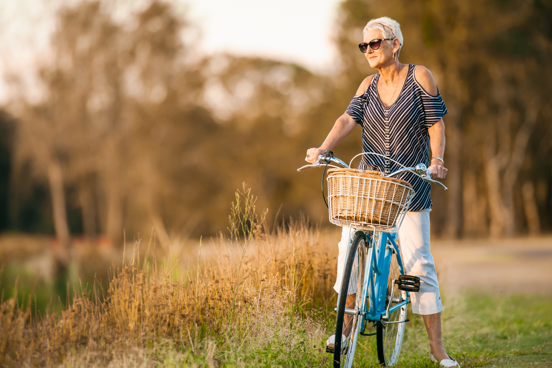 Close up shot of women on a bike with scenic background 