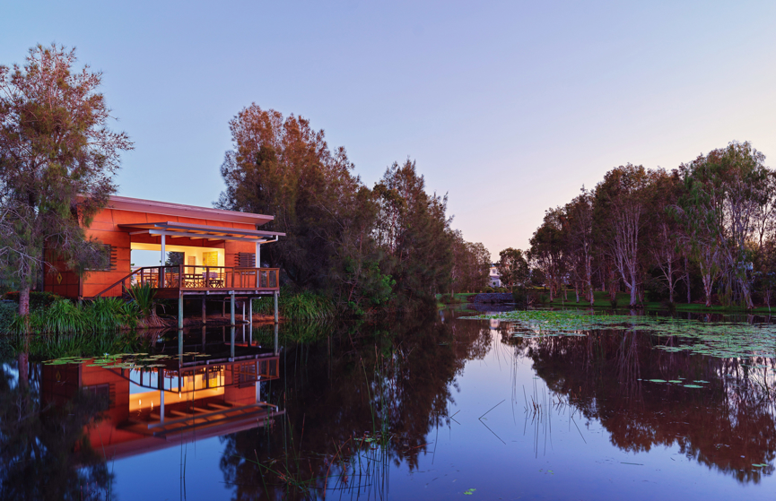 Exterior shot of the Halcyon Waters lake house and lake