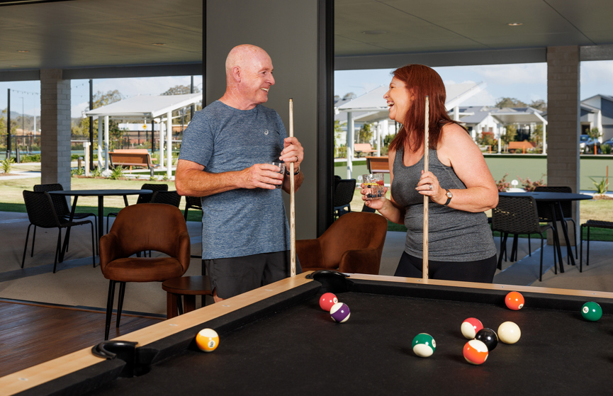 A couple in their 60s enjoying a game of pool at the Recreation Centre at Halcyon Rise.