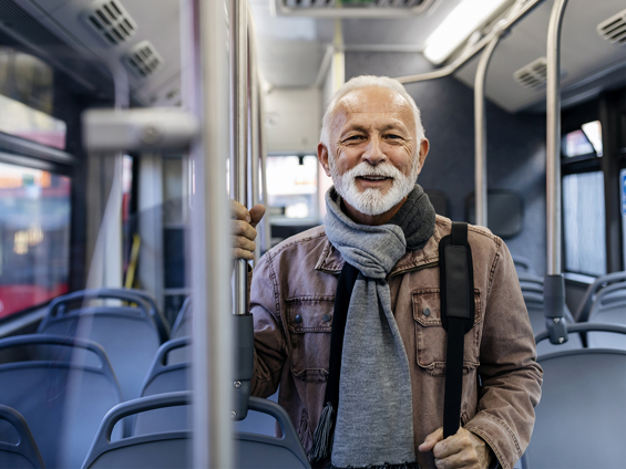 A man smiling on a bus.