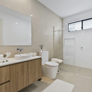 bathroom with timber vanity, light beige tiles and walk in shower