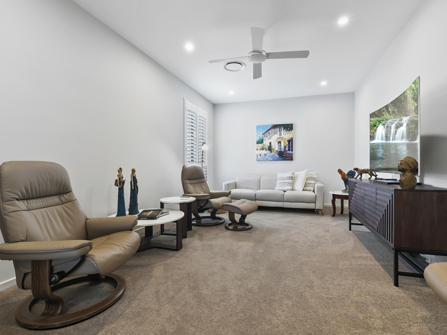 media room with modern furniture white walls and light brown carpet