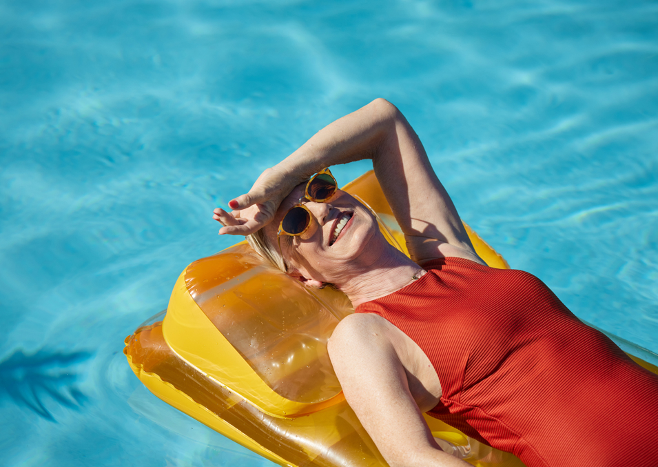 A lady relaxing on an inflatable lounge in the pool