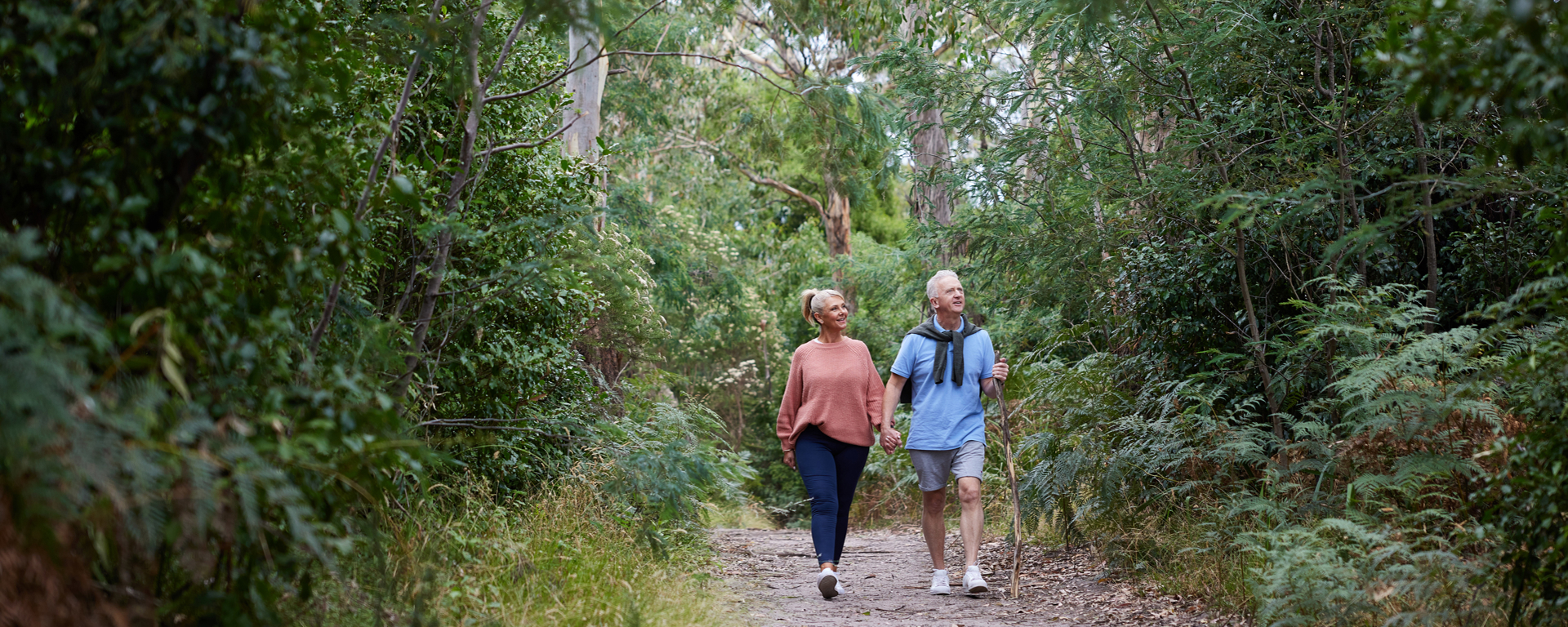 Couple walking a lovely bush track 