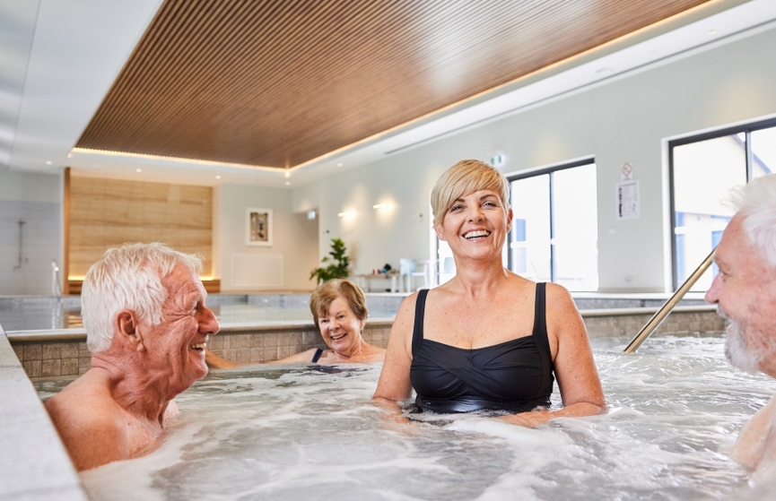 Homebuyers enjoying clubhouse facilities, relaxing in the spa