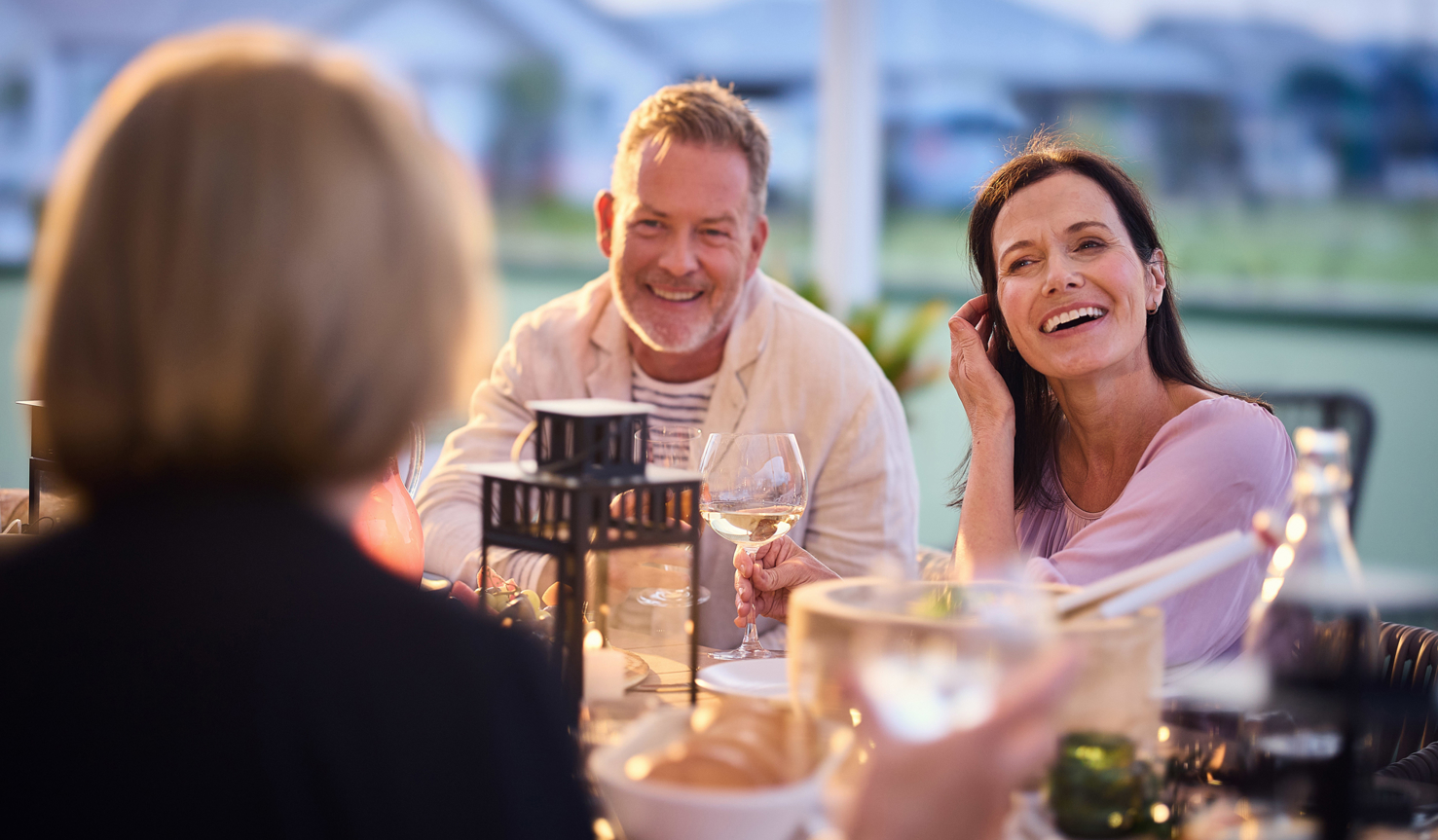 Homebuyer couple having a dinner party with friends