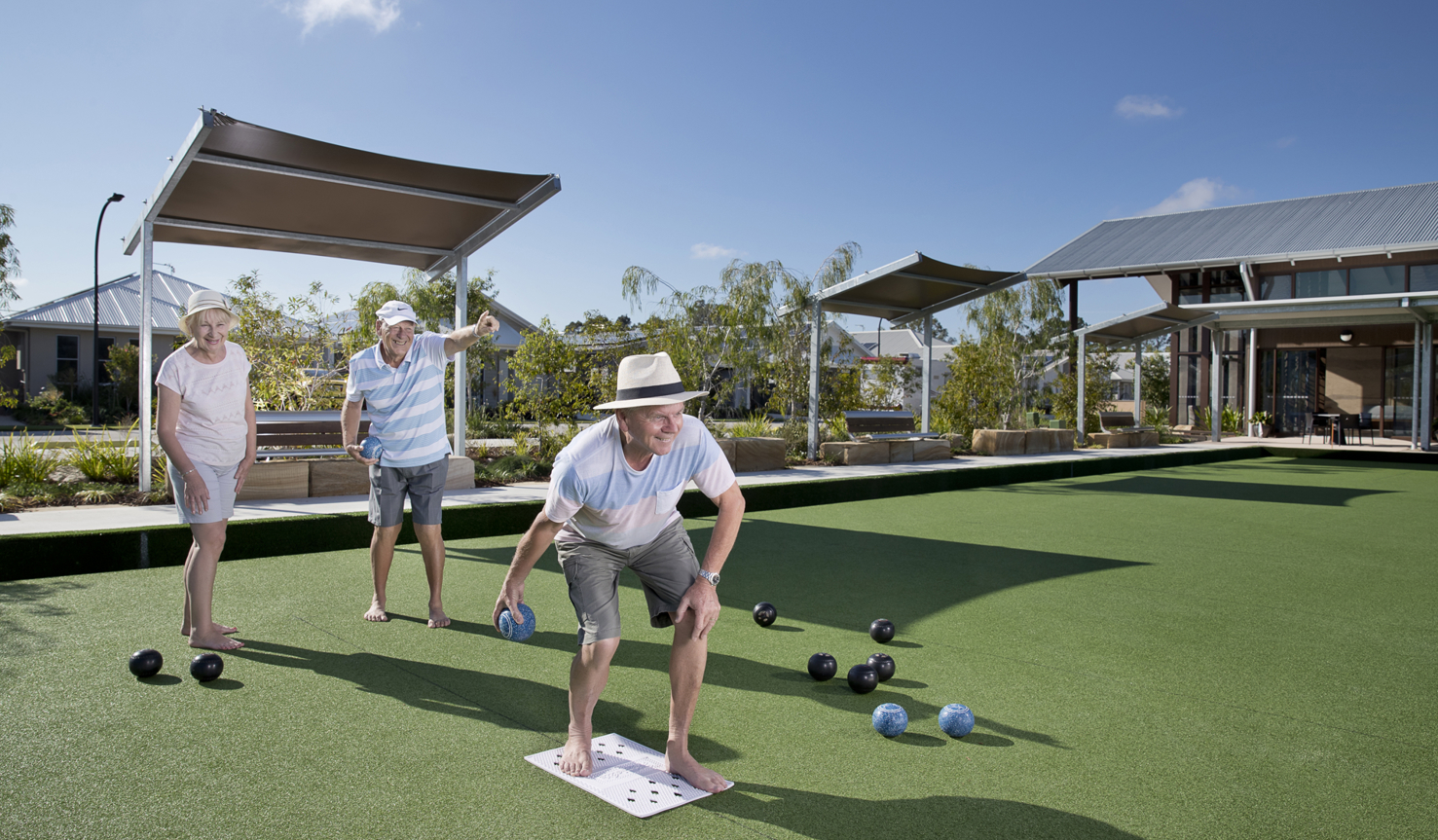 Halcyon Glades residents playing bowls on a green court