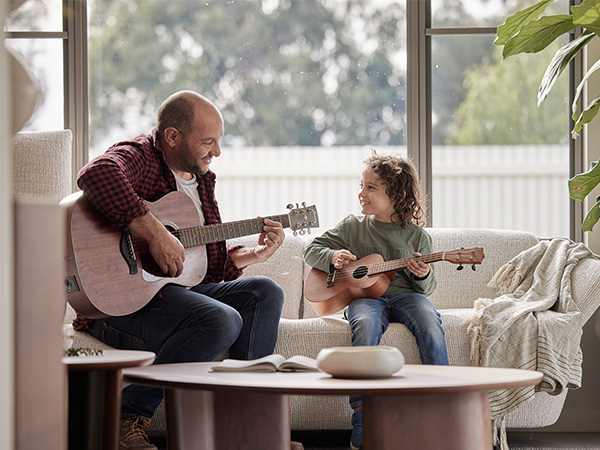 Father and son playing guitar