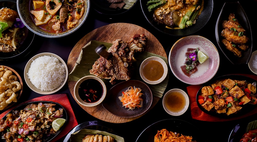 An array of Filipino dishes including Pork Sisig, Kansi, Crispy Pata, Kare Kare and Chibok Bok.