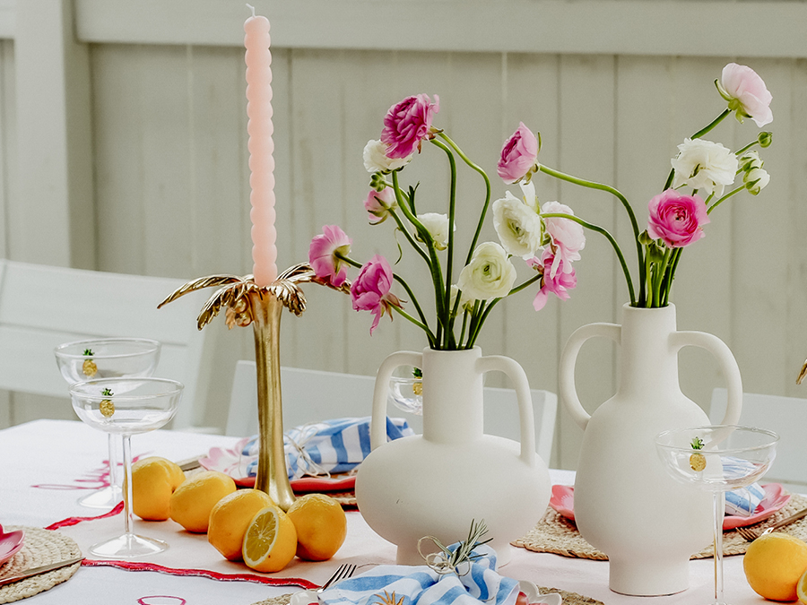 Table styled with vases, candles and fruit