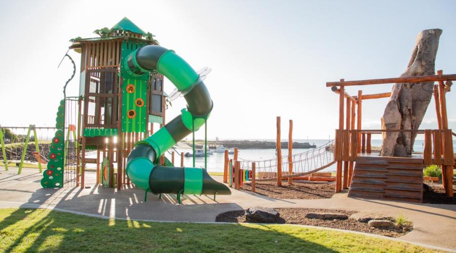 Children's playground with slide and climbing equipment at Forest Reach