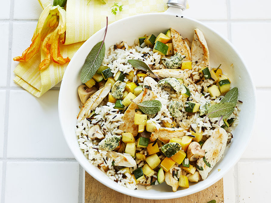 Rice bowl with chicken breast, zucchini and sage