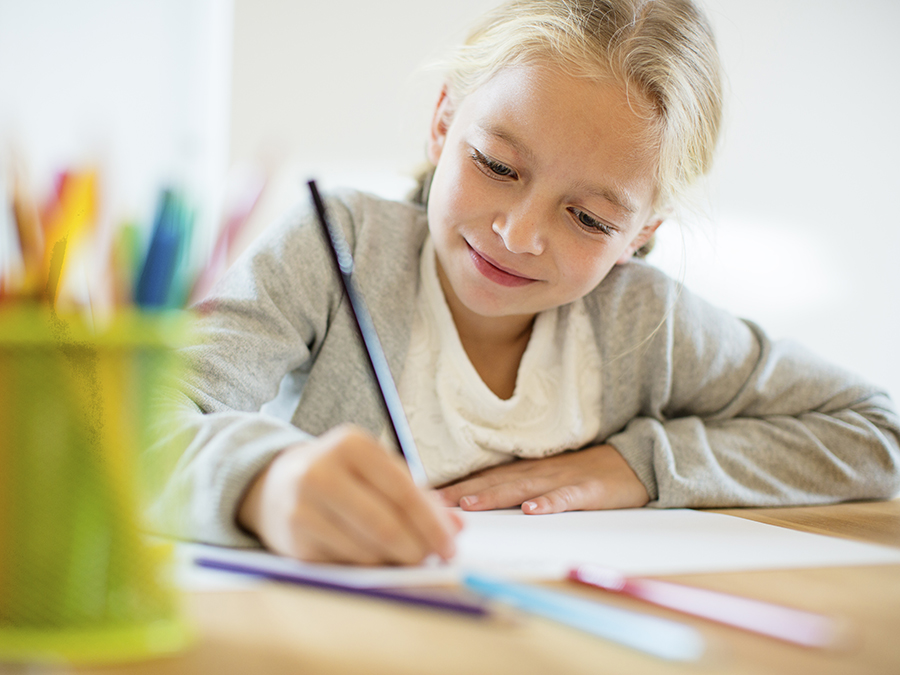 Young girl writing notes on a piece of paper
