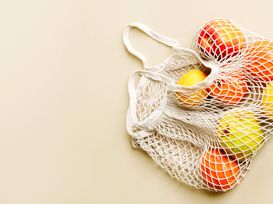 Oranges and lemons in a mesh shopping bag