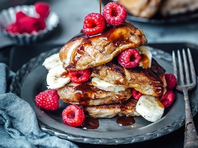 Leftover hot cross bun French toast with raspberries, banana and melted chocolate