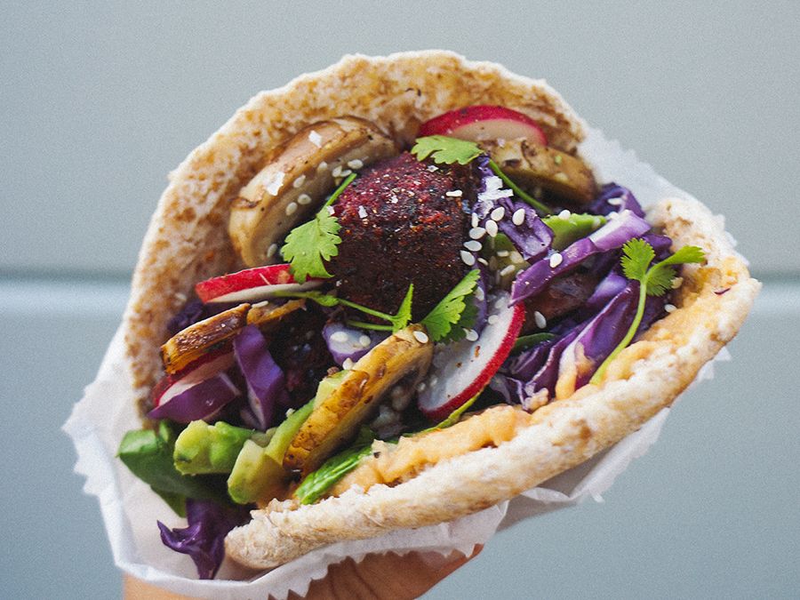 Pitta bread filled with beetroot falafel and mixed salad. 