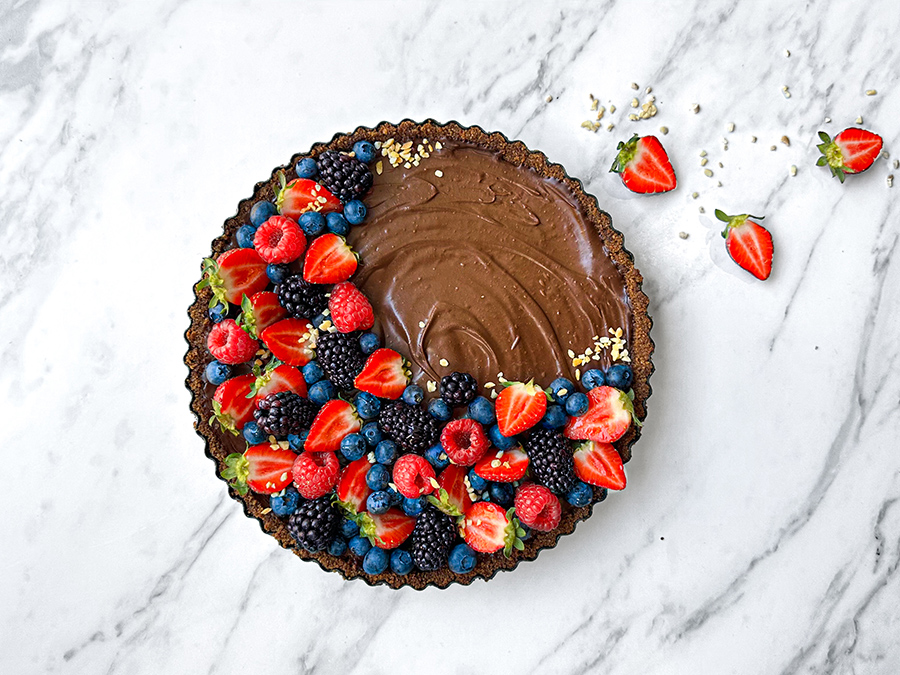 No bake chocolate tart with seasonal berries on top.