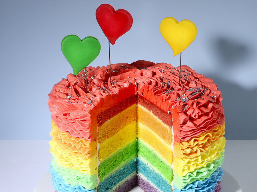 Layered rainbow cake with heart decorations