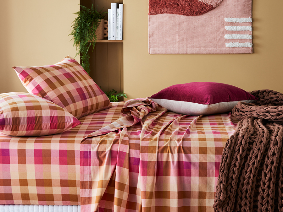 Use checked patterned linen and trending colours to style your bed