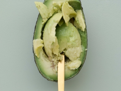 Ripe avocado with spoon